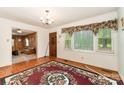 Cozy living room with hardwood floors, classic wood door, and large window offering plenty of natural light at 6934 Lockhart Rd, Sharon, SC 29742