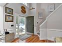 Bright foyer with hardwood floors, a staircase, and an open view to the front door and outside at 705 Moss Creek Dr, Matthews, NC 28105