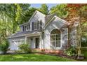 Charming two-story home featuring a well-manicured lawn, two car garage, and mature shade trees at 7226 Reedy Creek Rd, Charlotte, NC 28215