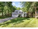 Charming two-story home with a well-maintained lawn, attached garage, and mature shade trees at 7226 Reedy Creek Rd, Charlotte, NC 28215