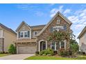 Charming two-story home boasts stone accents, blue shutters, and manicured landscaping at 9750 Briarwick Ln, Charlotte, NC 28277