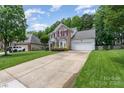 Beautiful brick front home with a two-car garage, long driveway, and manicured lawn at 10322 Stoneykirk Ln, Charlotte, NC 28269