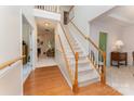 Welcoming foyer with hardwood floors, staircase, and view into the living room at 10322 Stoneykirk Ln, Charlotte, NC 28269