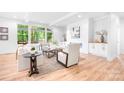 Bright and airy living room featuring a modern fireplace, hardwood floors, and large windows at 104 Arbor Dr, Waxhaw, NC 28173