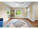 Bright living room with hardwood floors, large windows offering green views, and a charming decor, creating a cozy atmosphere at 108 Greenwood Ave, Belmont, NC 28012