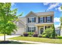 Charming two-story home featuring well-manicured lawn, attached garage and beautiful landscaping at 11101 Crane Creek Dr, Charlotte, NC 28278