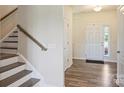Inviting foyer featuring hardwood floors, staircase and natural light at 11101 Crane Creek Dr, Charlotte, NC 28278