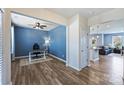 Office space with wood floors, a ceiling fan, and a view of the adjacent living area at 11101 Crane Creek Dr, Charlotte, NC 28278
