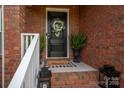 Close-up of the front door with wreath and potted plants, welcoming entrance at 1111 Lizzie Ln, Salisbury, NC 28147