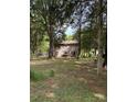 Spacious backyard featuring a patio with an umbrella table and chairs, as well as a swing set for leisure at 11718 Battery Pl, Charlotte, NC 28273