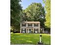 Charming two-story home with a well-manicured front lawn, blue door, and classic black shutters on a sunny day at 11718 Battery Pl, Charlotte, NC 28273
