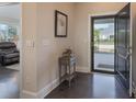 Inviting entryway with dark wood floors, stylish table decor, and a view through the open front door at 148 Adelaide Way, Rock Hill, SC 29732