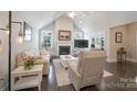 Cozy living room with fireplace, high ceilings, and neutral decor, flowing into other areas of the home at 148 Adelaide Way, Rock Hill, SC 29732
