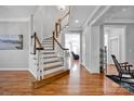 Elegant foyer with hardwood floors, staircase, and ample natural light streaming through nearby windows at 15430 Waterfront Dr, Huntersville, NC 28078