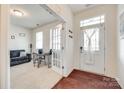 Bright foyer featuring hardwood floors, a stylish front door, and a cozy sitting room with a sofa at 1553 Arcadia Bluff Dr, York, SC 29745