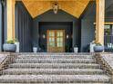 Inviting front porch with brick steps leading to a stunning double door entrance and stylish lighting at 167 Greenbay Rd, Mooresville, NC 28117