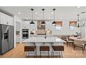 Spacious kitchen featuring a large island with seating, modern appliances, and stylish pendant lighting at 2004 Waxhaw Crossing Dr, Waxhaw, NC 28173
