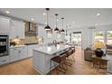 Open-concept kitchen with a center island, stainless steel appliances, and seamless flow into the living area at 2004 Waxhaw Crossing Dr, Waxhaw, NC 28173