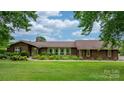 Lovely brick home with lush green lawn and colorful flowerbeds enhancing its curb appeal at 2448 Moss Farm Rd, Hickory, NC 28602
