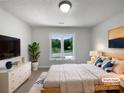 Comfortable bedroom with a large window, soft lighting, and elegant decor at 2532 Steeplechase Rd, Gastonia, NC 28056