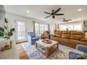 Inviting living room with hardwood floors, ceiling fans, and french doors leading to outdoor views at 2702 Oxborough Dr, Matthews, NC 28105