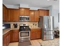 This kitchen features stainless appliances, granite countertops and plentiful wood cabinets with a wood backsplash at 3306 Yarmouth Ln, Gastonia, NC 28056