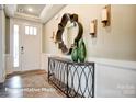 Inviting hallway with hardwood floors, decorative mirror, and stylish console table at 3315 Whispering Creek Dr # 95, Wesley Chapel, NC 28079