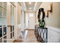 Inviting hallway with hardwood floors, decorative mirror, and stylish console table at 3315 Whispering Creek Dr # 95, Wesley Chapel, NC 28079