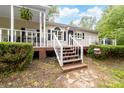 Inviting front porch with white railings, wooden deck, and manicured hedges at 3716 Hamilton Dr, Gastonia, NC 28052