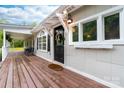 Welcoming front porch features a black door, wooden deck, and lantern lighting at 3716 Hamilton Dr, Gastonia, NC 28052
