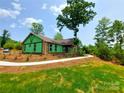 New construction home with a concrete walkway and landscaping at 401 Constant Ln, Charlotte, NC 28722