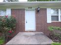 Charming brick house featuring a well-manicured lawn and inviting front entrance at 409 Anne Ave, Waxhaw, NC 28173
