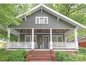 Charming home showcasing a welcoming front porch with white railings and a red brick staircase at 501 E Tremont Ave, Charlotte, NC 28203