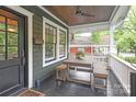 Charming front porch with a wooden dining table, benches, and covered ceiling at 501 E Tremont Ave, Charlotte, NC 28203