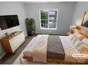 Serene main bedroom with a cozy rug, dresser and natural light at 524 N Portman Ln, Fort Mill, SC 29708
