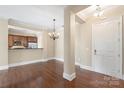 Spacious living room with hardwood floors, elegant chandelier, and an open layout for entertaining at 5425 Closeburn Rd # 208, Charlotte, NC 28210