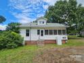Back of home with screened porch, brick foundation, and steps at 562 W Wilson Ave, Mooresville, NC 28115