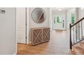 Elegant foyer with wood floors, decorative mirror, and staircase leading to the upper level at 5812 Dinsmore Ln, Belmont, NC 28012
