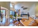 Elegant living room with hardwood floors, high ceilings, large windows, and stylish decor at 5826 Natoma Rd, Lake Wylie, SC 29710