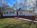 Charming single-story home features a well-maintained lawn, and colorful shrubbery, complemented by a quaint front porch at 7154 Woodcock Trl, Stanley, NC 28164