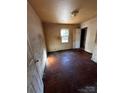 View of a bedroom, needs significant renovation, featuring a window to the outside at 722 S Weldon St, Gastonia, NC 28052