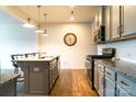 An open kitchen features granite countertops, stainless steel appliances, and gray cabinets at 7416 Hartsfield Dr, Lancaster, SC 29720