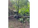 Charming home with front porch surrounded by lush foliage offering a serene, private approach at 8504 Knollwood Cir, Charlotte, NC 28213