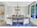 Elegant dining room with stylish chandelier, large window and seating for six at 8692 Acadia Pkwy # 591, Sherrills Ford, NC 28673
