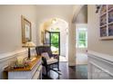 Entrance foyer with hardwood floors, neutral walls, and a view into other rooms of the home at 8818 Artesa Mill Ln, Charlotte, NC 28214