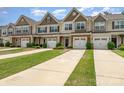 Charming townhomes featuring attached garages, manicured lawns, and stylish exterior finishes at 12408 Savannah Cottage Dr, Charlotte, NC 28273