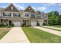 Charming townhomes featuring attached garages, manicured lawns, and stylish exterior finishes at 12408 Savannah Cottage Dr, Charlotte, NC 28273