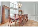 Formal dining room with hardwood floors, large window, and an elegant chandelier at 1305 Yellowood Ct, Rock Hill, SC 29732