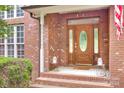 Elegant brick entryway with a beautiful wooden door, sidelights, and decorative touches at 1305 Yellowood Ct, Rock Hill, SC 29732