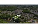 Gorgeous aerial view of home's location on private, wooded lot with lake access and community amenities at 132 Flora Vista Dr, Mooresville, NC 28117